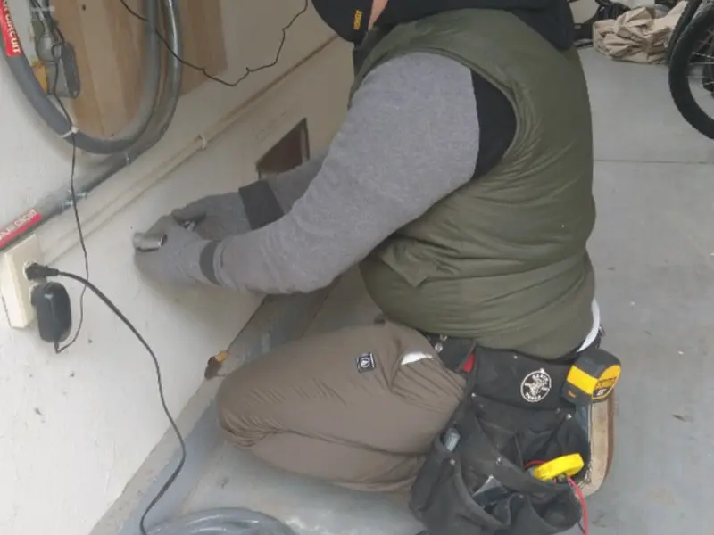 Electrician performing outlet wiring in a Dewey-Humboldt garage